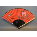 A Japanese Fan, the red paper leaf hand painted with birds amongst foliage with shaped lacquered