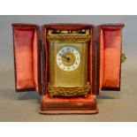 A 19th Century French Brass Cased Carriage Clock of shaped form with engraved decoration, the enamel