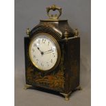A Late 19th Century Lacquered Mantel Clock with Chinoiserie decoration, the shaped top with brass