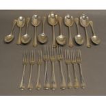 An Edwardian Silver Canteen of Flatware comprising nine three pronged forks and eleven spoons,