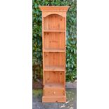 A 20th Century Pine Bookcase, the moulded cornice above open shelves with drawer below, raised