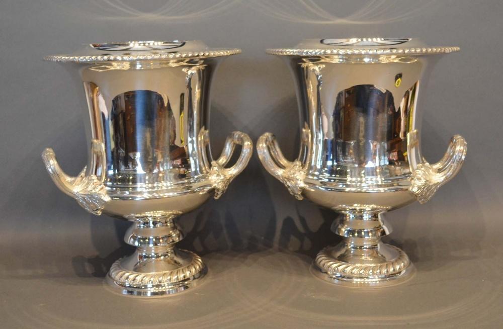 A Pair of Silver Plated Wine Coolers with scroll side handles and circular pedestal bases, 28cm tall