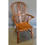 An Early 19th Century Elm Windsor Armchair with pierced splat and spindle back above a shaped seat