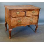 A George III Walnut Lowboy, the moulded crossbanded and quarter veneered top above two short and one