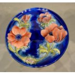 A Moorcroft Commemorative Plate for 1982, Anemone pattern, tubelined on a blue ground, 22cm diameter