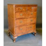 An Early 20th Century Walnut Queen Anne Style Chest, the crossbanded top above two short and three