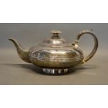 A George IV Silver Teapot of melon form with shaped handle, London 1825, maker's mark WT, 21oz