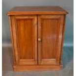 A Victorian Mahogany Low Cupboard, the moulded top above two doors raised upon a plinth, 65cm