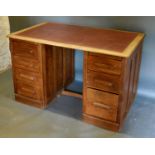 An Early 20th Century Twin Pedestal Desk, the leather inset top above seven drawers with cup