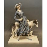 A Goldscheider Porcelain Group in the form of a girl with dog, 31cm tall