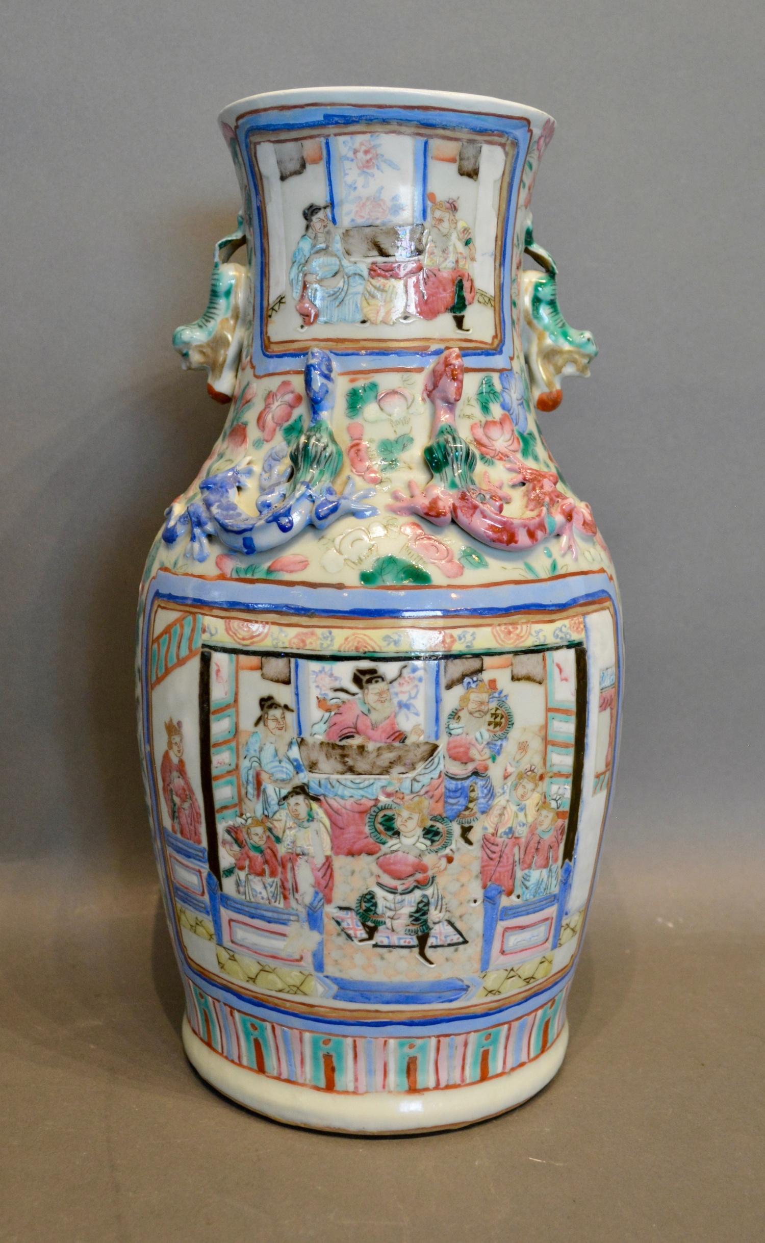 A 19th Century Canton Vase decorated in polychrome enamels with figures within landscapes, 34cm tall