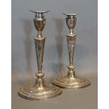 A Pair of Edwardian Silver Candlesticks, each with a removable sconce upon oval bases, London