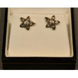 A Pair of Yellow Metal Diamond Set Ear Studs of flower head form, each set with six diamonds