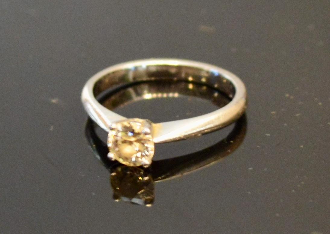 A White gold Solitaire Diamond Ring with single diamond within a pierced setting, approximately 0.50