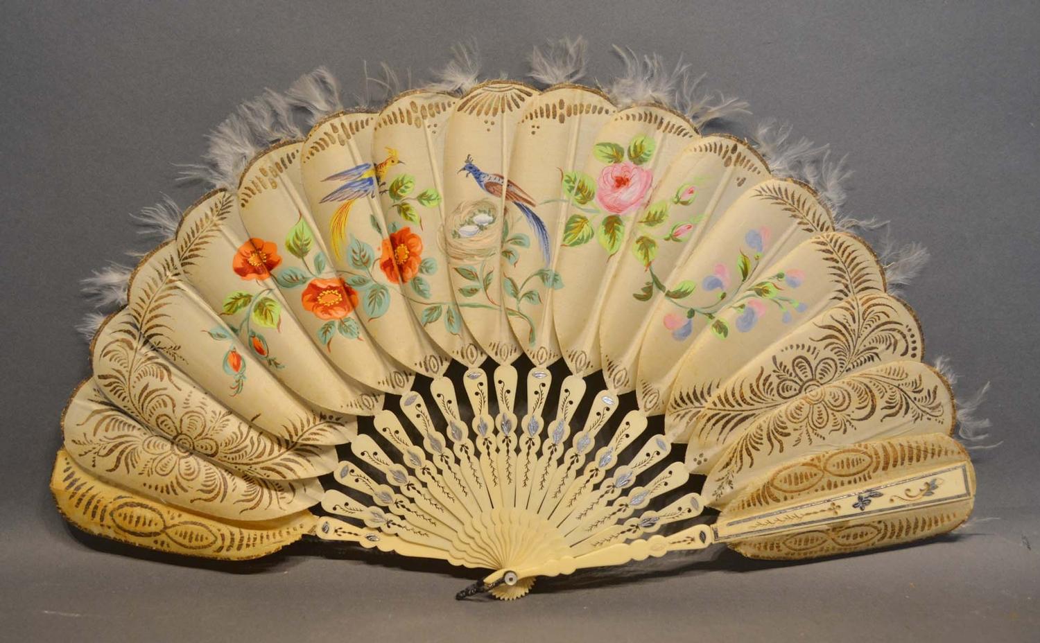 A Jenny Lind Fan, the silk feather style leaves hand painted with a peacock amongst foliage, the