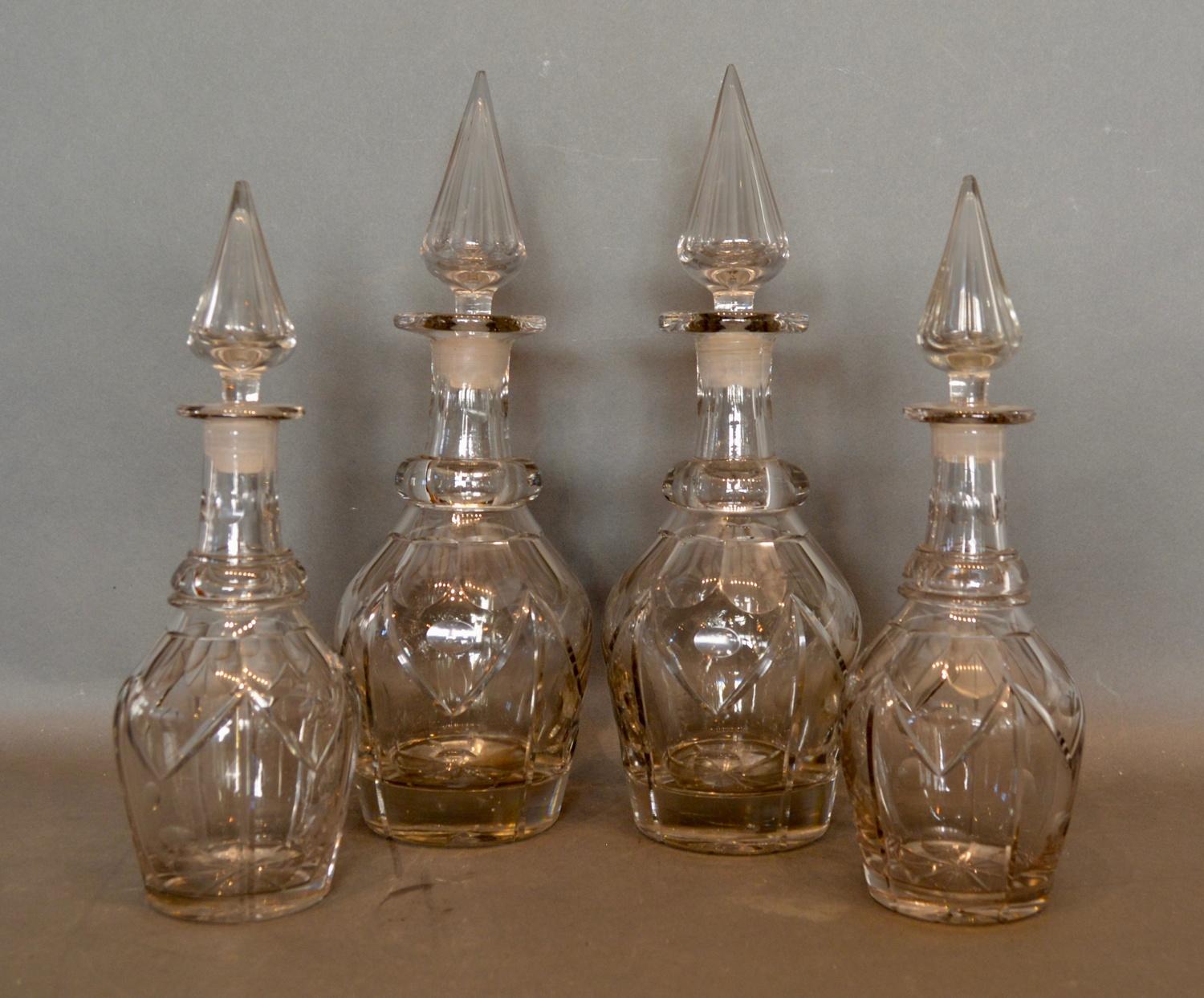 A Pair of 19th Century Glass Decanters with spire stoppers, together with a matching smaller pair,