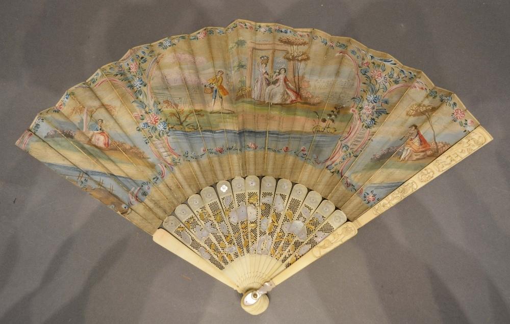 An 18th Century Fan, hand painted with classical figures within cartouches, the ivory pierced sticks