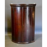 A George III Mahogany Bow-Fronted Hanging Corner Cabinet
