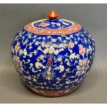 A Chinese Famille Rose Ginger Jar with allover decoration upon a blue ground and with four character