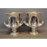 A Pair of Silver Plated Wine Coolers with scroll side handles and circular pedestal bases, 28cm tall