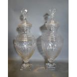 A Pair of Large Cut Glass Oviform Covered Vases of Ribbed form with square stepped bases, 70cm tall