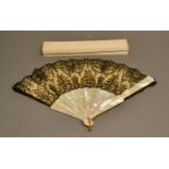 A 19th Century Chantilly Black Lace Fan with mother of pearl sticks and guards, rivets set with