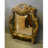 A 19th Century French Carved Wood and Gesso Wall Mirror of scroll shaped from 107cm high by 94cm