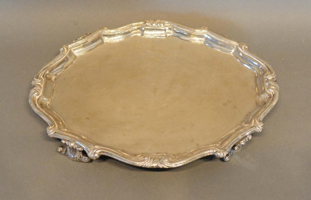 A Continental White Metal Salver, 18th/19th century, of shaped outline with four scroll feet,