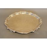 A Continental White Metal Salver, 18th/19th century, of shaped outline with four scroll feet,