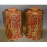 A Pair of Toleware Octagonal Covered Canisters, each with gilded Chinoiserie decoration on a red