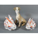 A Lladro Porcelain Model if the form of a dog together with two Japanese Imari models of rabbits