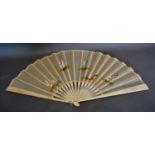 A Carved Bone Fan with silkwork leaf, hand painted with figures, 35cm long