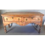 A George III Oak Dresser Base, moulded top above two drawers with brass drop handles and