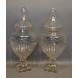 A Pair of Cut Glass Covered Vases of Shaped Form with ribbed decoration and square stepped bases