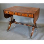 A Regency Style Mahogany Sofa Table, the reeded drop flap top above two frieze drawers with lion