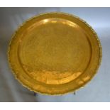 A Benares Brass Circular Tray with hardwood stand, 63cm diameter