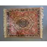 A North West Persian Silk Small Rug with a central medallion within an allover design upon a blue