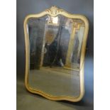 A Cream Painted and Gilded Wall Mirror of shaped form 91cm high by 67cm wide