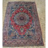 A Northwest Persian Carpet with a Central Medallion within an all over design on a red, blue and