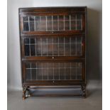 An Early 20th Century Oak Globe Wernicke Style Three Section Bookcase with lead glazed doors