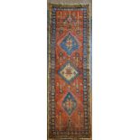 A North West Persian Woollen Runner with three medallions with an allover design upon a pale blue