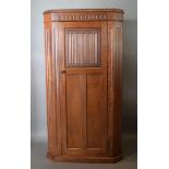 An Early 20th Century Oak Hall Wardrobe with a linenfold panel door raised upon a plinth, 94cm wide,