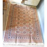 A Turkish Woollen Rug with three rows of guls within an all over design upon a cream and