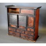 A Korean Table Cabinet with an arrangement of sliding doors and drawers, 71cm wide, 27cm deep,