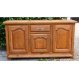 A 20th Century Oak Dresser Base with heavy plank top above a central drawer and cupboard flanked