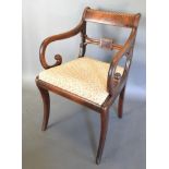 A William IV Mahogany Armchair with a rail back above a drop in seat raised upon sabre legs