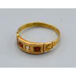 A 15ct Gold Ring with central diamond flanked by rubies 2grams, ring size O