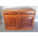 A 19th Century Mahogany Side Cabinet with a moulded top above two frieze drawers with knob handles