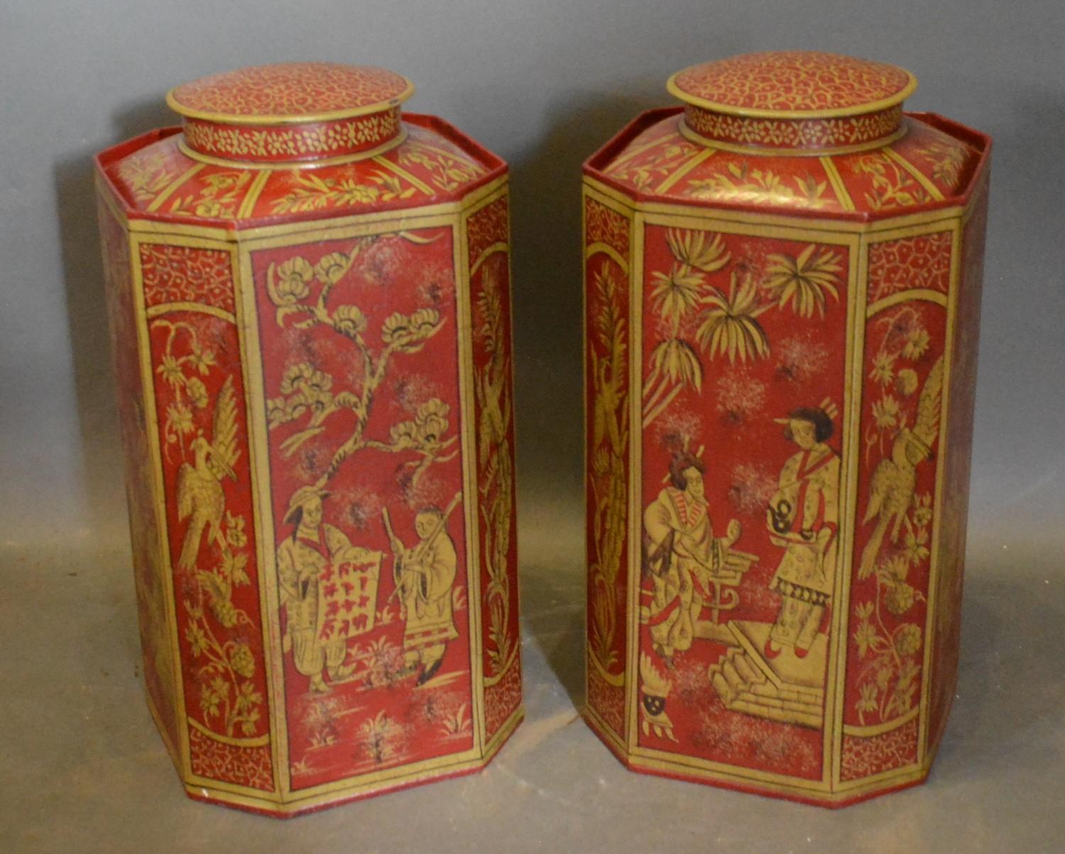 A Pair of Toleware Octagonal Covered Canisters, each with gilded Chinoiserie decoration on a red