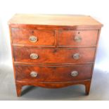 A Victorian Mahogany Bow-Fronted Chest of two short and two long drawers with oval brass handles